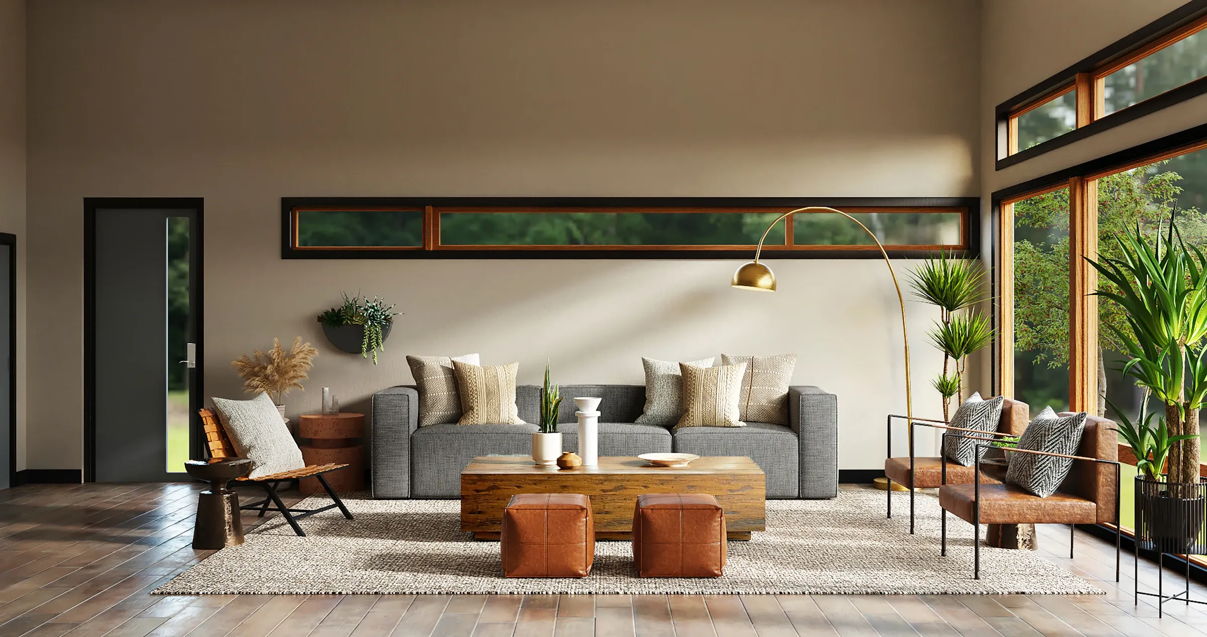 Salon lumineux avec canapé gris, poufs en cuir et grandes baies vitrées ouvertes sur la verdure